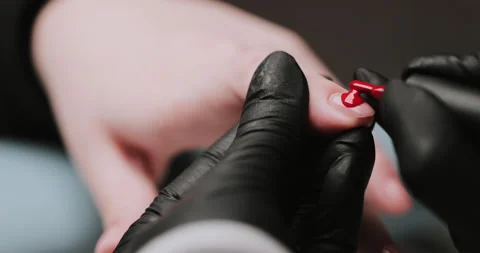 Close Up of master in rubber gloves covering red nails  Video stock 149367594