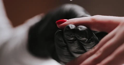 Close Up of master in rubber gloves covering red nails with top coat  Stock Footage 149367689