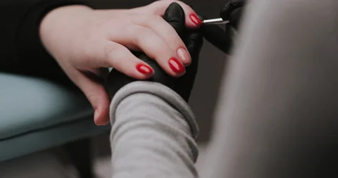 Close Up of master in rubber gloves covering red nails  Video stock 149367810
