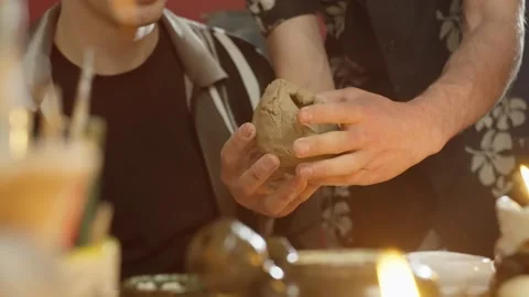 Close-up of master's hands helping students sculpt ceramics from clay Stock-Footage 248439059