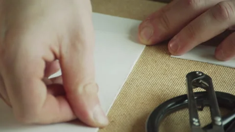 Close-up of the master's hands make a neat and precise fold of paper for making Stock Footage 143722038