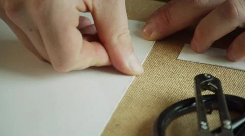 Close-up of the master's hands make a neat and precise fold of paper for making 스톡 사진