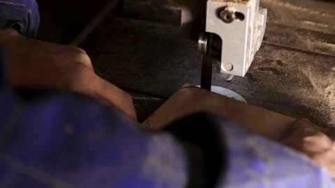 Close-up of the master's hands working on a band saw Stock-Footage 100756889