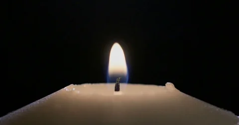 Close up of a match lighting a candle wick Stock Footage 74349807