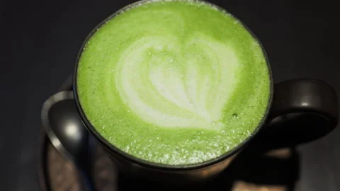 Close up of a matcha latte on a tray at a cafe Stock Footage 304261932