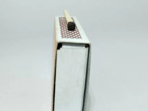 Close up of a matches on a Scraping surface. A Match being lit with the str.. Stock Photos