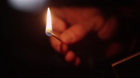 Close up of a matchstick being lit in a dark void Video stock 153243318