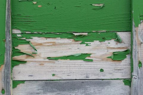 Close-up material texture of peeling green paint on wooden boards Stock Photos