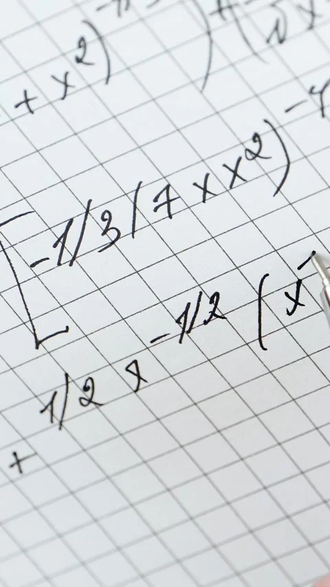 Close-up of mathematical formulas on graph paper. Student writes calculations Stock Footage 345476577