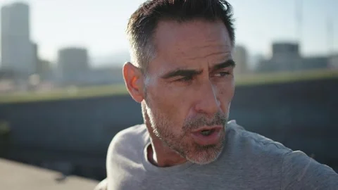 Close up mature Caucasian man relaxing after running on urban. Male runner Stock Footage 272273553