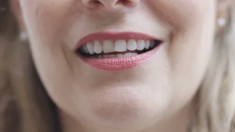Close up of mature female's mouth as she talks cheerfully in a conversation Stock Footage