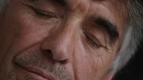 Close up on mature man with closed eys opening Stock Footage