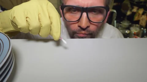 Close up of mature man's face. He is concentrated on cleaning white shelf of Stock-Footage 127746059