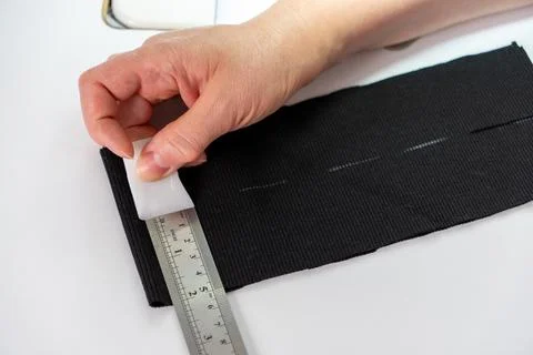Close up of measuring and marking fabric for tailoring Stock-Fotos