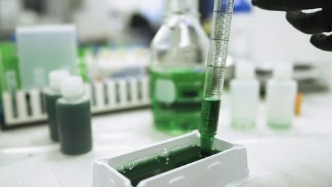 Close up Measuring green liquid in scientific lab looking for a cure to a virus Stock Footage 127532771