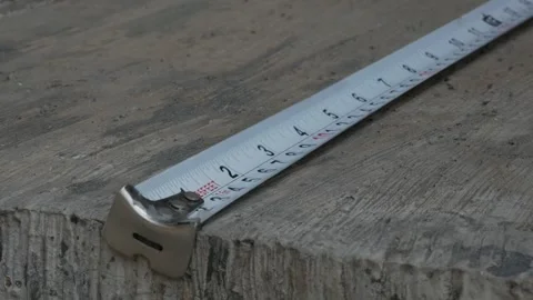 Close Up of Measuring Tape on Concrete Surface for Dimension Measurement Stock Footage 340424129