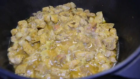 Close up meat and vegetables in cauldron. Pieces of meat and a lot of onions are 動画素材 119860469