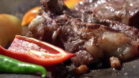 Close-Up of Meat and Vegetables Grilling on Stone Over Campfire 動画素材 317887856