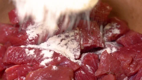 Close up of meat with flour on a plate Stock Footage 248180947