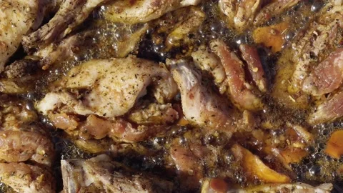 Close-up meat pieces are fried in oil on an open fire of a wood-burning stove. Stock-Footage 219349574