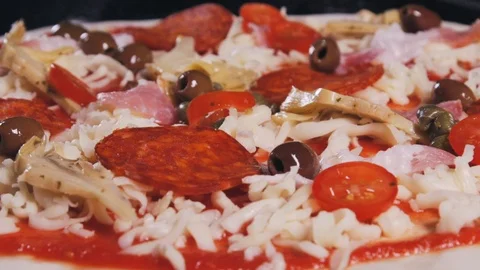 Close up of meat pizza which is decorated with capers in slow motion. Stock Footage 112652886