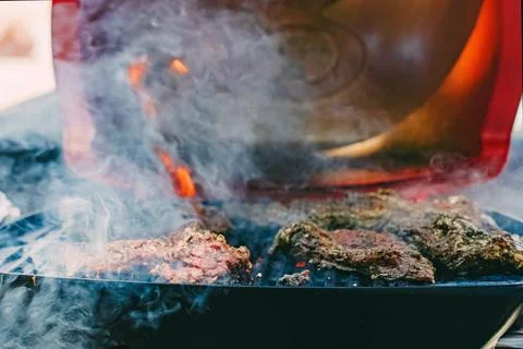 Close-up of meat roasting on the grill. Stock Photos