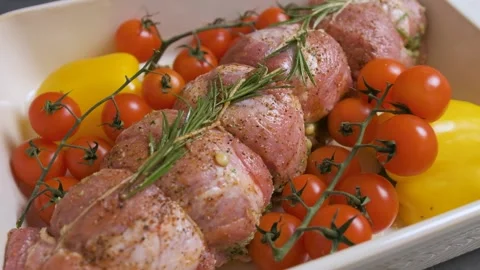 Close up of a meat with vegetables arranged in the baking tray, prepares the Stock Footage 143261161