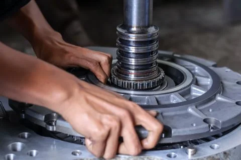 Close up of a mechanic assembling an industrial machine transmission componen Stock Photos