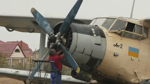 Close-up of mechanic checking engine of an old Soviet aircraft Antonov An-2R, Stock Footage 38391356
