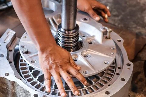 Close Up of Mechanic Hands Assembling Transmission Housing and Gear Shaft C.. Stock Photos
