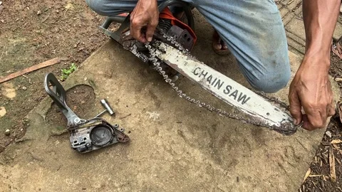 Close Up Mechanic Hands Fixing Chainsaw Chain Stock Footage 326132285