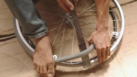Close-up of Mechanic Hands Installing Wheelchair and Fitting Rubber Tire Stock Footage 336712868