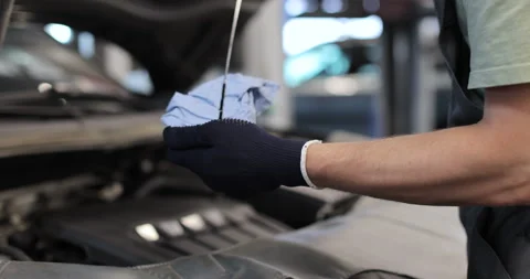 Close up mechanic man checking an engine oil for maintenance Stock Footage 341867882