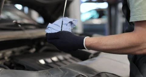 Close up mechanic man checking an engine oil for maintenance and repair at .. Stock Photos