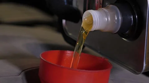 Close-up of a mechanic pouring new engine oil into the engine. Stock Footage 339788338