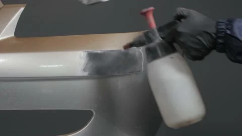 Close-up of a mechanic preparing a car body for painting Video stock 202166877