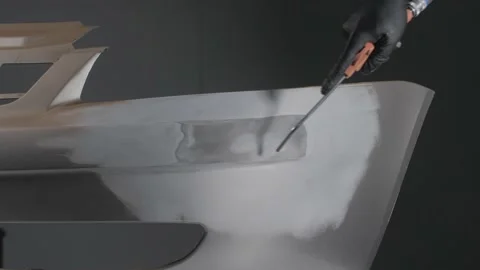 Close-up of a mechanic preparing a car body for painting. Car body polishing. Stock-Footage 202169281