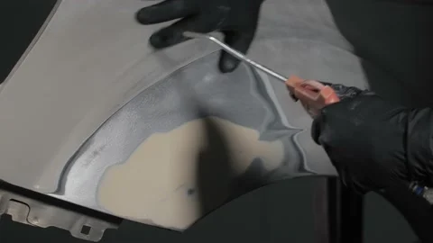 Close-up of a mechanic preparing a car body for painting. Car body polishing. Video stock 202170749
