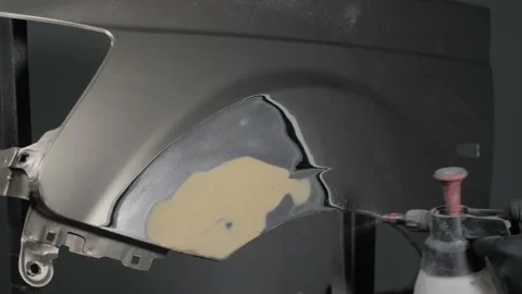 Close-up of a mechanic preparing a car body for painting Video stock 202174660