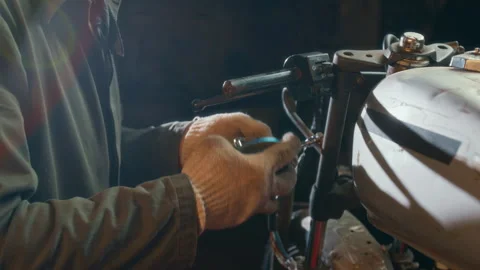 Close-up of Mechanic Removing Rearview Mirror from Motorcycle to Replace It Stock Footage 312703283