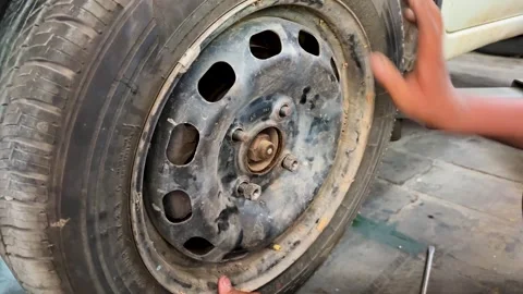 Close Up Of Mechanic Securing Wheel Nuts During Tire Replacement At Auto Stock Footage 340954746