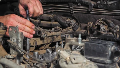 Close-up of the mechanic tightens the bolt by tool in 4K (UHD) Video stock 128584534