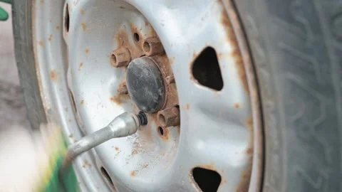 Close-up of a mechanic unscrewing a nut and removing Видео 337550699