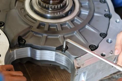 Close up of a mechanic using an allen key to assemble an industrial engine .. Stock Photos