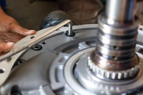 Close up of a mechanic using an allen key to assemble an industrial machine.. Stock Photos
