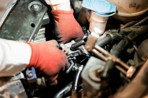 Close-Up of a Mechanic Working on an Engine Component 스톡 사진