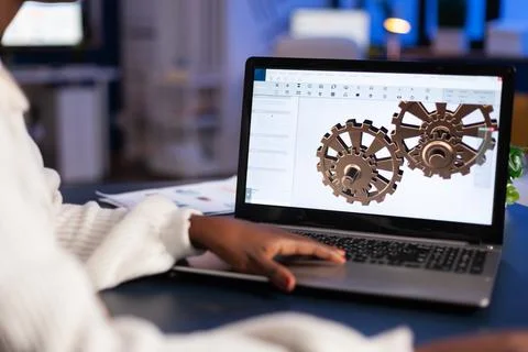 Close up of mechanical gears while engineer working with software Stock Photos