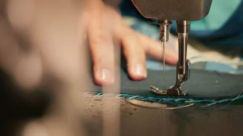 Close-up of a mechanical sewing machine needle and presser foot stitching d.. Stock Footage 342582860
