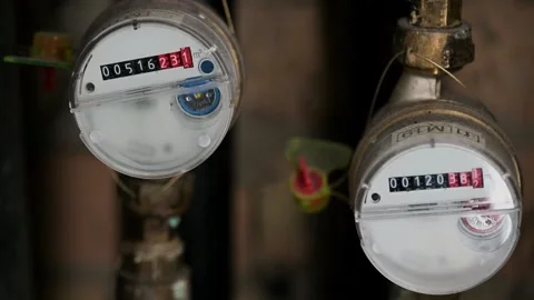 Close-up of a mechanical water meter on a blurred pipe background Stock Footage 328533587