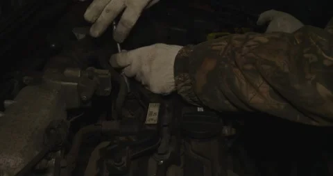 Close-up of a mechanic's hands, wearing white gloves and camouflage jacket Video stock 306404604